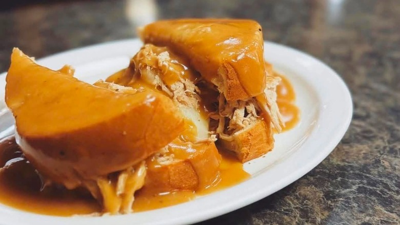 Hot shredded Pork Sandwich on white bread smothered with gravy at J's Homestyle Cooking restaurant