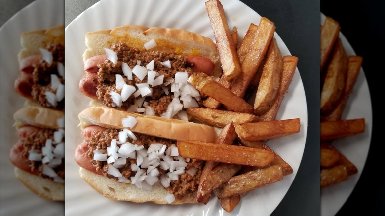 Hot dog with chilli and onions with side of French Fries at TASTee GRILL
