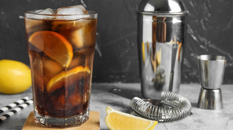 Long Island Iced Tea cocktail with bartending equipment