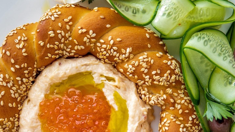 Middle Eastern spread in center of bread and pickles