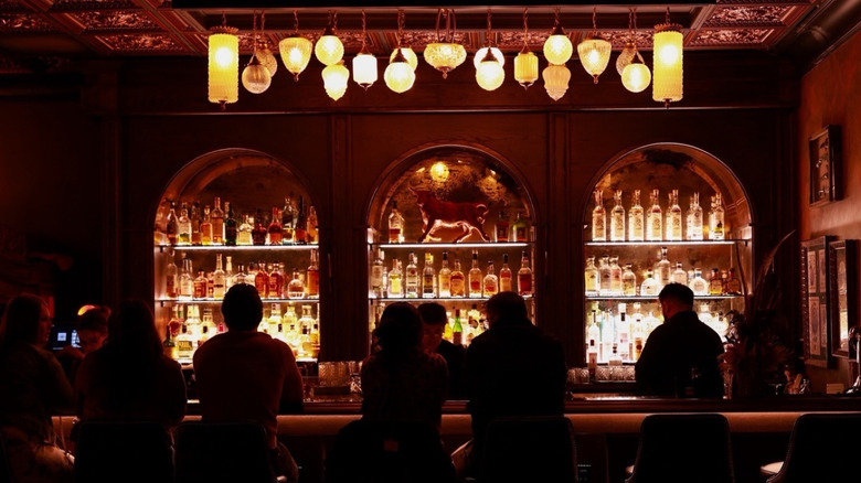 darkly lit bar with people sitting