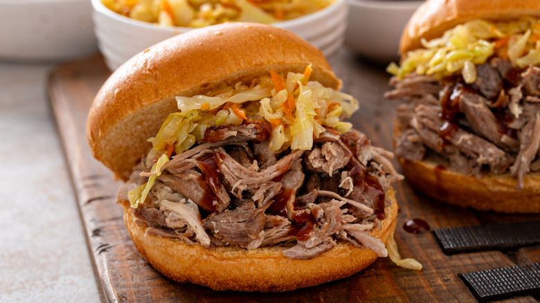 Pulled pork sandwiches on brioche buns with BBQ sauce and sauteed cabbage