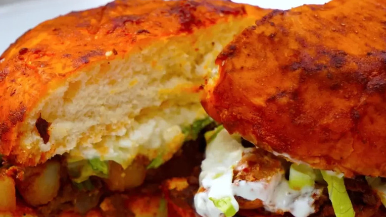Bread buns cut in half and filled with chorizo, diced potatoes and a creamy sauce