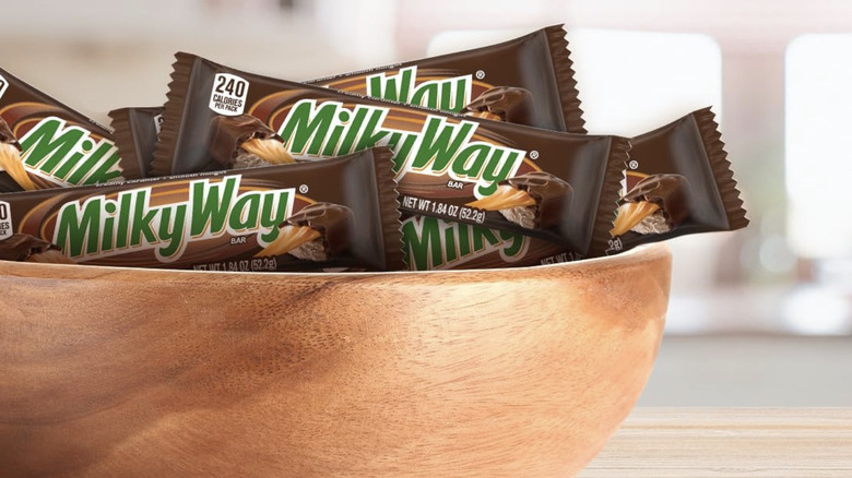 Milky Way Chocolate Bars placed in a wooden bowl.