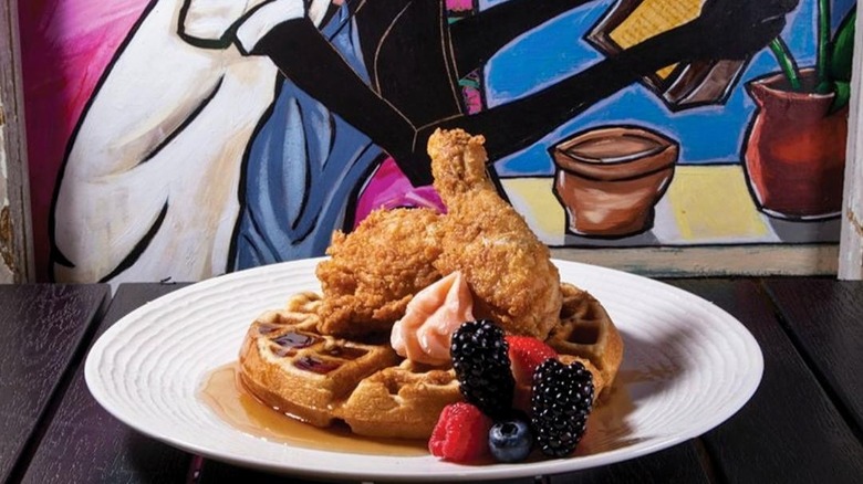 Fried chicken on top of waffle with berries
