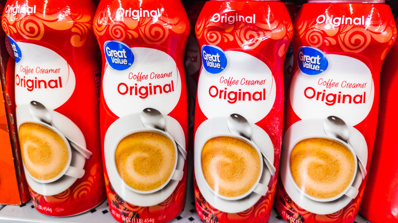 Containers of coffee creamer on the shelf at the grocery store.