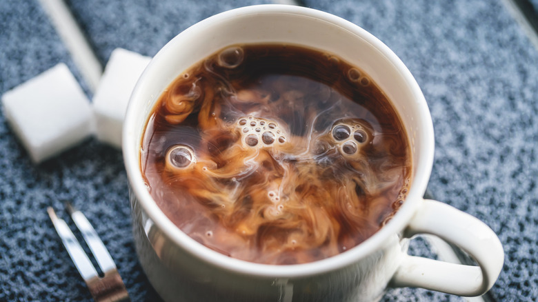 Mug with coffee and creamer