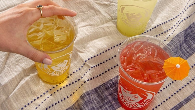 Hand reaching for cup of Wendy's lemonade