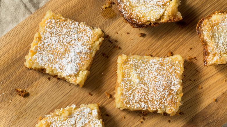 Homemade gooey butter cake squares on a wood platter