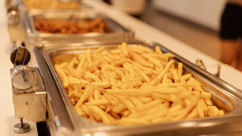 A buffet tray filled with French fries