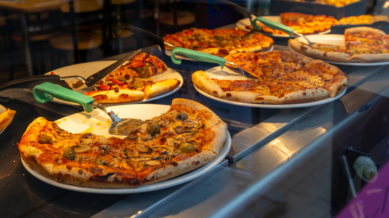 Different pizzas served buffet-style.
