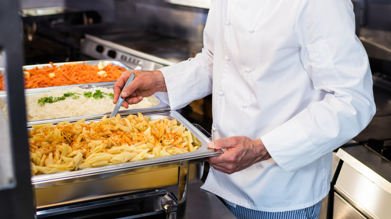 A chef preparing buffet items