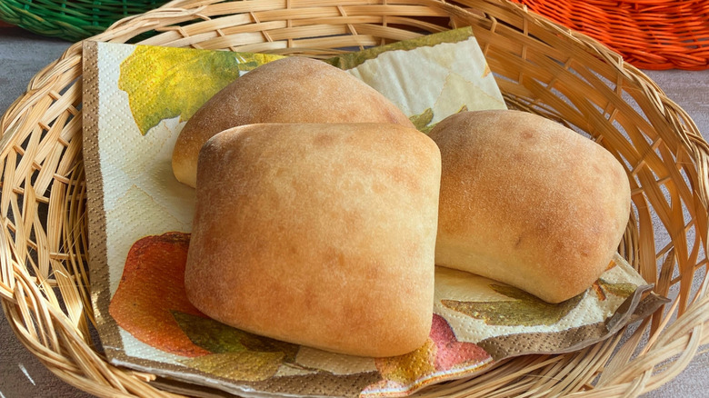 square, baked rolls displayed in a bread basket