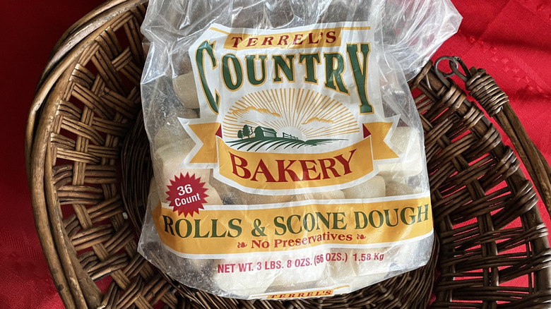 A bag of Terrel's Country Bakery Rolls & Scone Dough in a brown basket on a red tablecloth