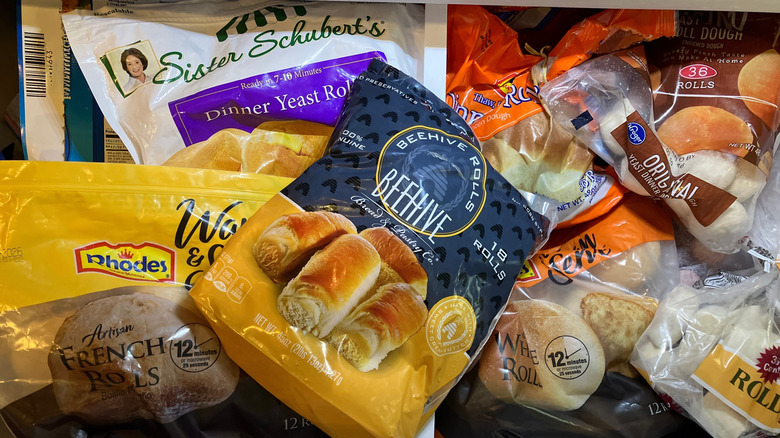 a freezer drawer full of various brands of frozen rolls