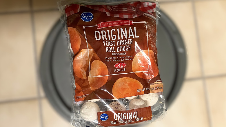 A bag of Kroger frozen rolls in focus with the background blurred