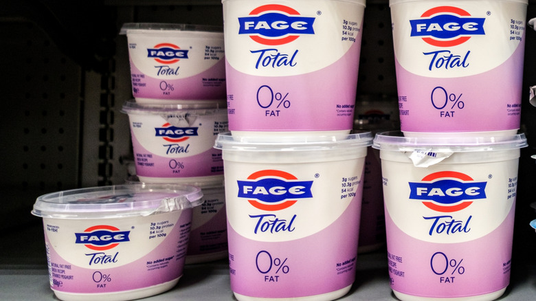 Containers of FAGE Total 0% yogurt on refrigerator shelves