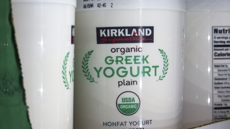 Containers of Kirkland Signature Organic Greek Yogurt are displayed at a Costco Wholesale store