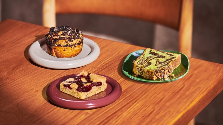Three new Starbucks bakery items that have debuted in 2026 on a wooden table
