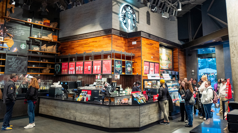 Customers waiting in line inside Starbucks coffee shop