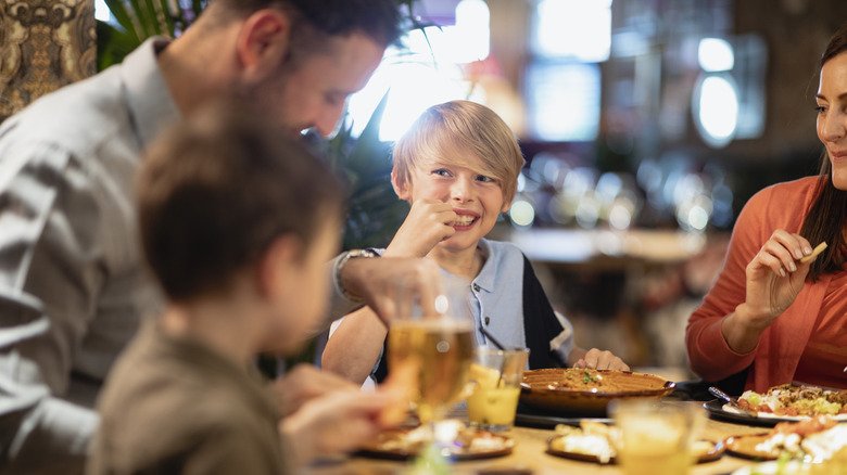 A family with kids eating at a restaurant