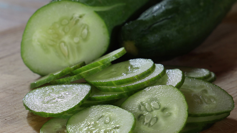 whole cucumber and slices of cucumber