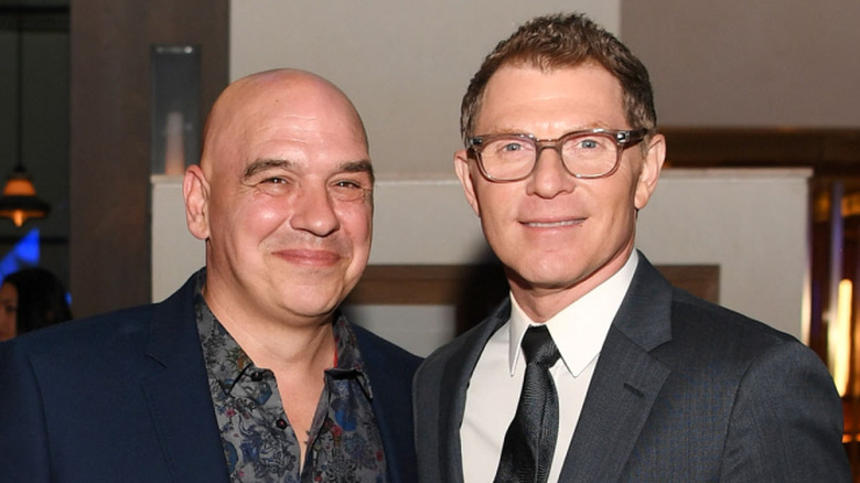 Chefs Michael Symon and Bobby Flay posing together