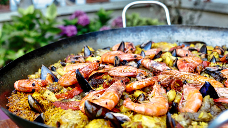 paella cooking in shallow pan