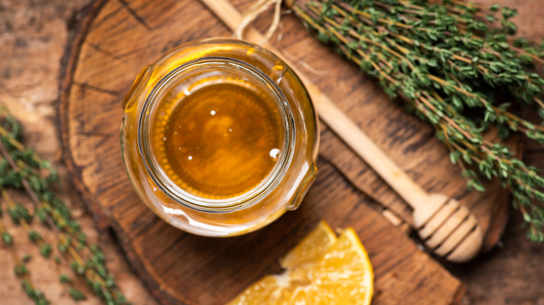 honey on table with thyme