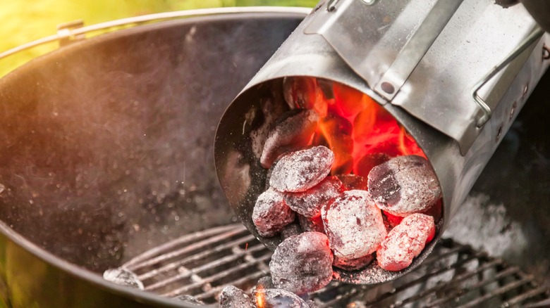 pouring hot coals out of chimney starter into grill