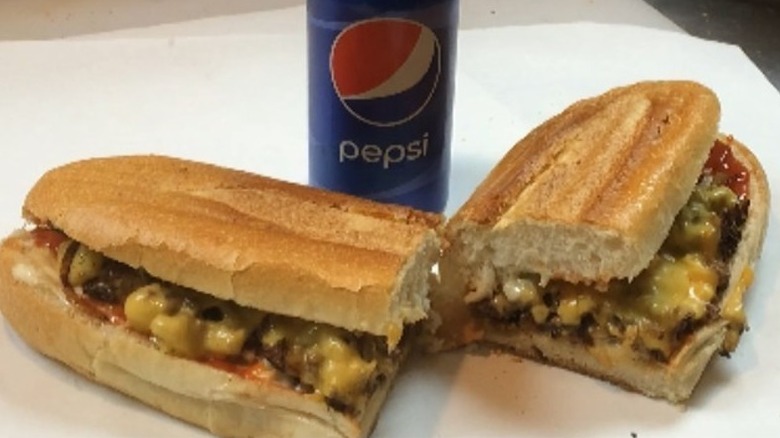 Chopped cheese sandwich with a bottle of Pepsi