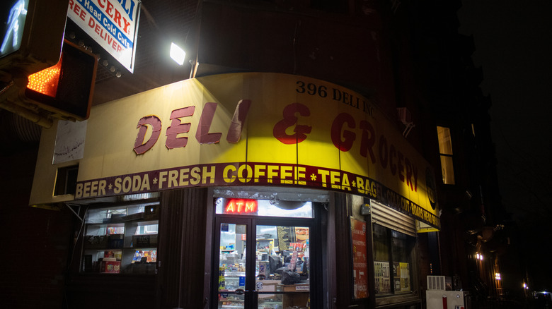Exterior of a New York City deli, night