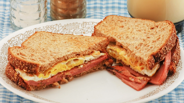 Fried bologna and egg sandwich on a white plate