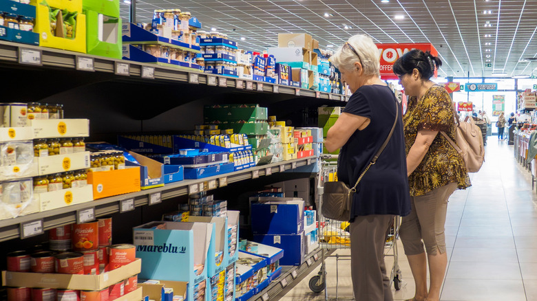An elderly woman shopping in a discount grocery store