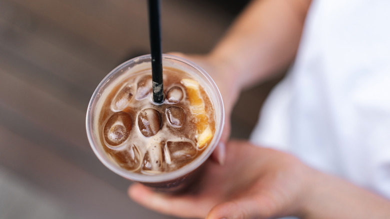 Someone holding an iced coffee drink