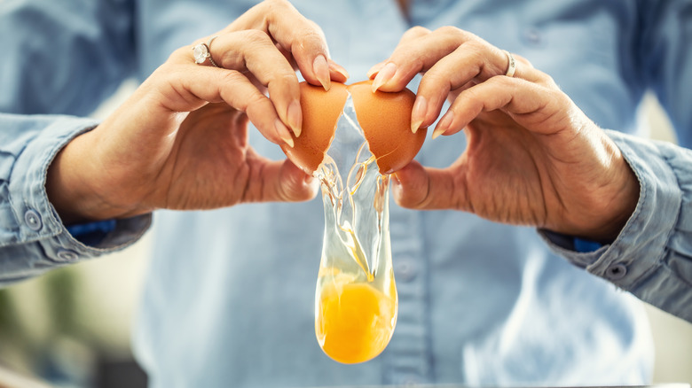 Person cracking an egg