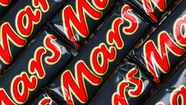 A number of Mars bars lined up with each other.