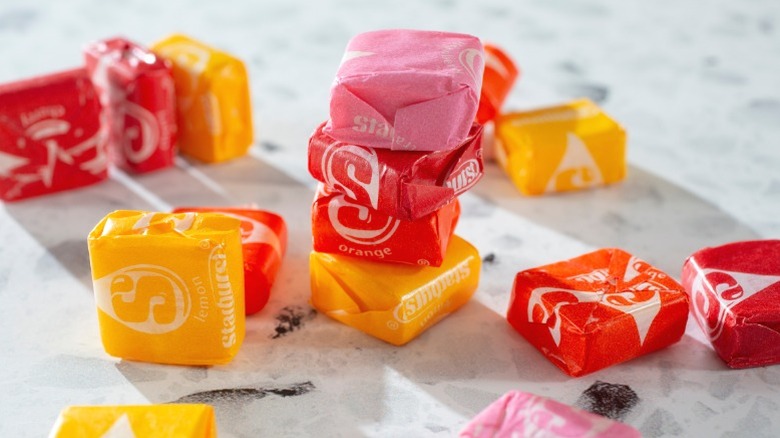 A pile of Starburst candy on a white countertop.