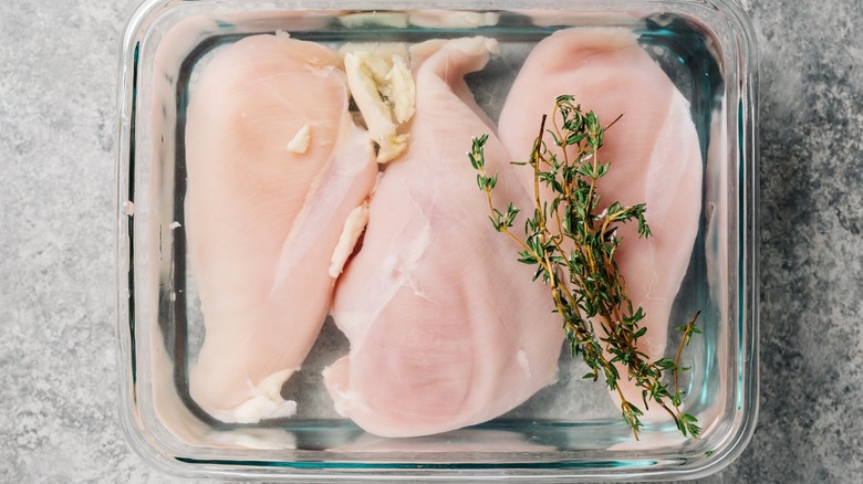 Chicken in brine with thyme sprig on top