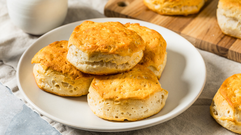 A stack of homemade biscuits on a white plate