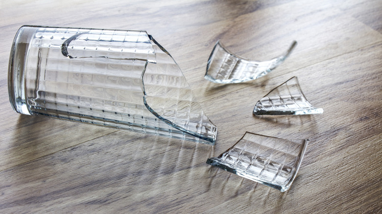 A broken champagne flute on a white background