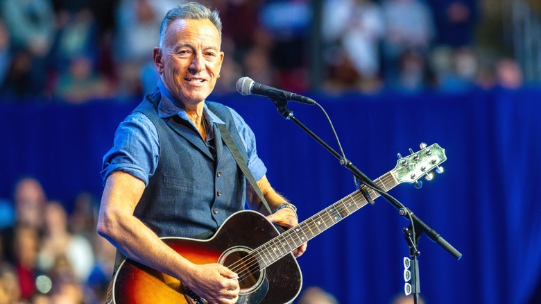Musician Bruce Springsteen performing on stage.
