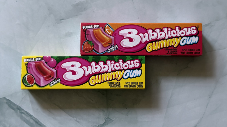 two packs of Bubblicious Gummy Gum on countertop. One flavor is strawberry and orange and the other is watermelon.