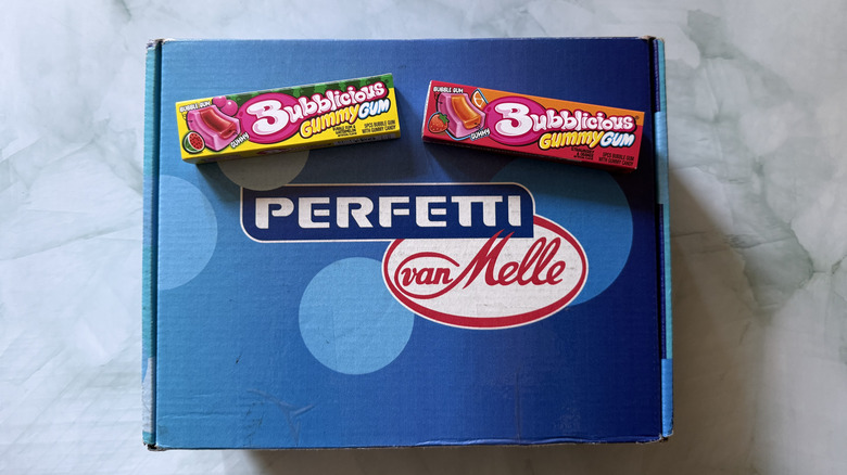 Two packs of Bubblicious Gummy Gum in watermelon and strawberry and orange flavors on top of a box from Perfetti van Melle brand