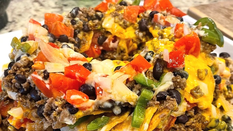 Football nachos made with tortilla chips and toppings in a bundt pan