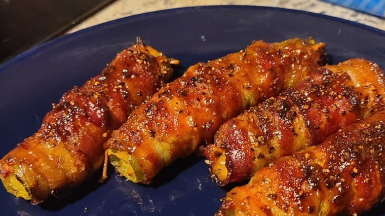 A snack plate of pickle poppers wrapped with bacon
