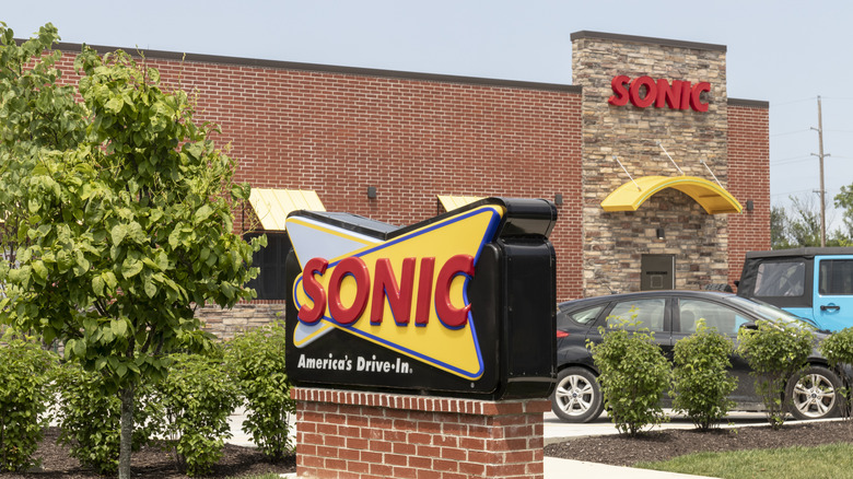 Sonic Drive-In exterior with cars parked outside.