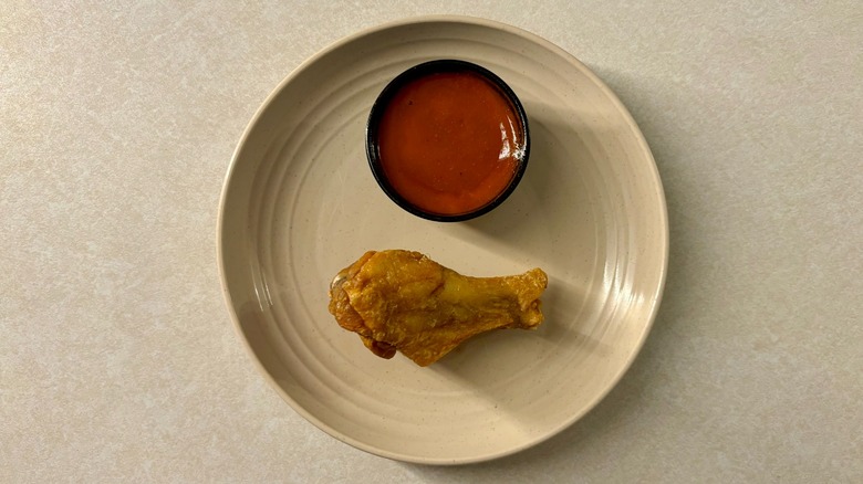 Buffalo Wild Wings Hot sauce and wing on plate