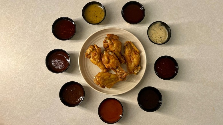 Chicken wings on plate surrounded by buffalo wild wings sauce