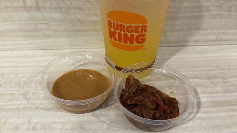 A cup of BBQ sauce and brisket